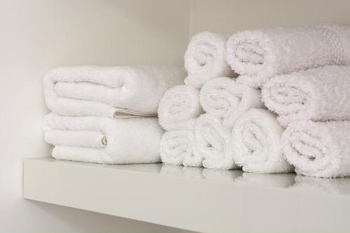 a pile of towels sitting on a shelf at InStyle Aparthotel in St Julian's