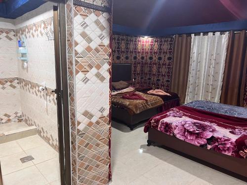 a bedroom with two beds and a mirrored wall at Shakria Bedouin Life Camp in Wadi Rum