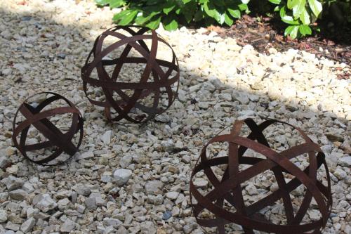three metal spheres sitting on a rocky ground at Ferienwohnung Novotny in Lörrach