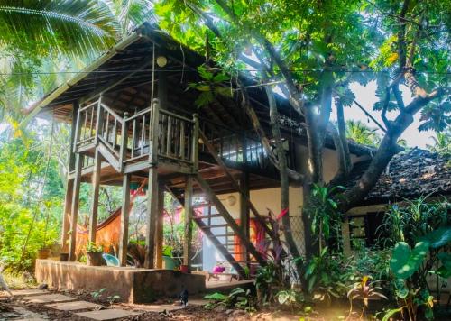 a tree house in the middle of a forest at The Wild Flower! in Anjuna
