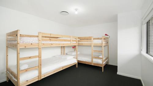 two bunk beds in a room with a window at The Palms - Lennox Head in Lennox Head