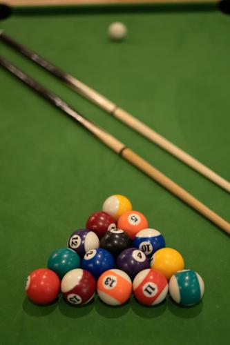 a group of billiard balls on a pool table at Capsule Marrakech I Chicha I Sauna I Balnéo I Console PS5 I Cinéma in Trith-Saint-Léger
