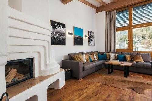 a living room with a couch and a fireplace at Serfaus Alpensuites in Serfaus