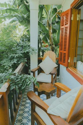 a balcony with a chair and a plant at The Wooden Gate in Xuân Sơn