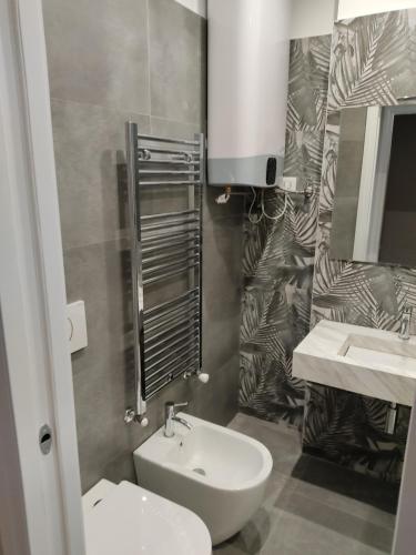 a bathroom with a sink and a toilet and a mirror at City Life Top apartment in Milan