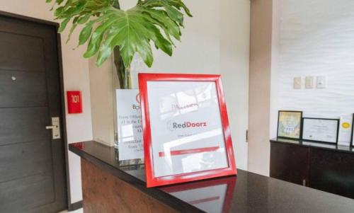 a red box on a counter in a room at RedDoorz Hostel @ Tita Aidz Inn Baguio in Baguio