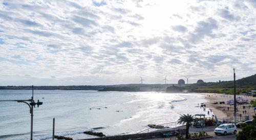 a view of a beach with windmills in the distance at Nanwan station in Nanwan