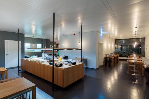 a kitchen with a counter and some tables and chairs at mk monteurzimmer stuttgart in Stuttgart