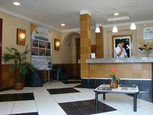 a waiting room with a person talking on a cell phone at Raio de Sol Praia Hotel in Fortaleza