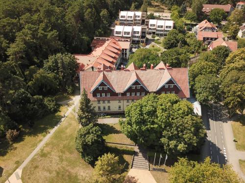 an aerial view of a large house with trees at Hotel Jurate in Nida