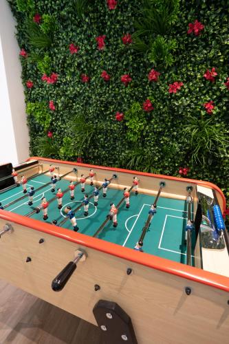 a pool table with a soccer game on it at Capsule Thailande I Sauna I Balnéo I Console I jeux en bois I Cinéma I cour intérieure in Trith-Saint-Léger