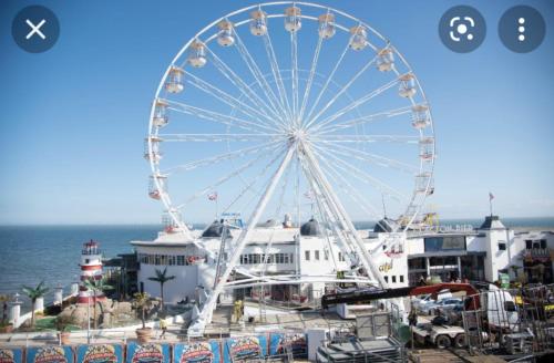 a ferris wheel at a pier next to the ocean at Exquisite holidays letting for 3 nights starting from £90 in Jaywick Sands
