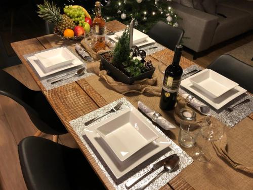 a dining room table with a christmas tree in the background at Chalet Slovensky Raj in Smižany