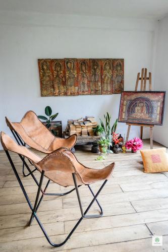 a room with a chair and a painting on the wall at GODDESS Kandy in Kandy