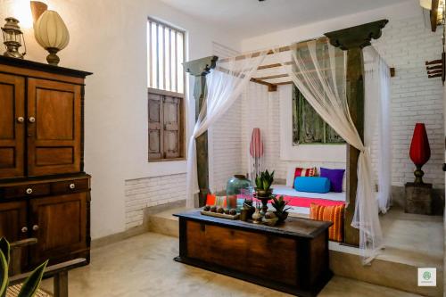 a living room with a bed and a table at GODDESS Kandy in Kandy