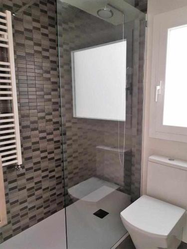 a bathroom with a glass shower with a toilet at Roses Casc Antic SL Avda Rodhe in Roses