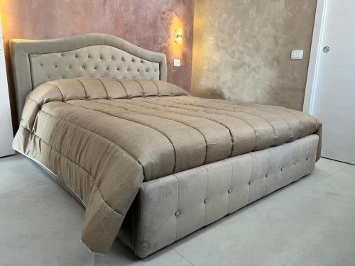 a bedroom with a large bed with a large headboard at Residence Giove in Castelfranco Veneto