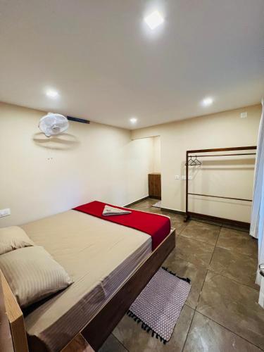 a bedroom with a bed in a room at Davis Farm House in Marayoor