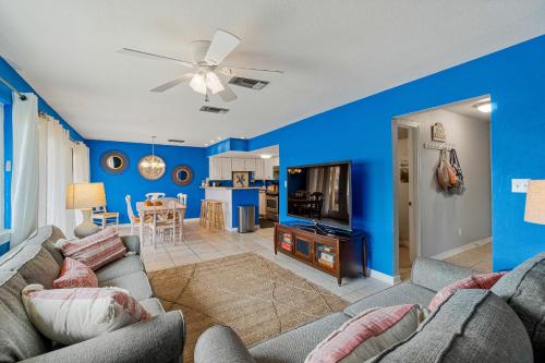 a living room with blue walls and a couch at Regency Cabanas #D4 in Pensacola Beach