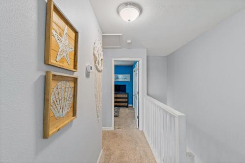 a hallway with two pictures on the wall at Regency Cabanas #D4 in Pensacola Beach