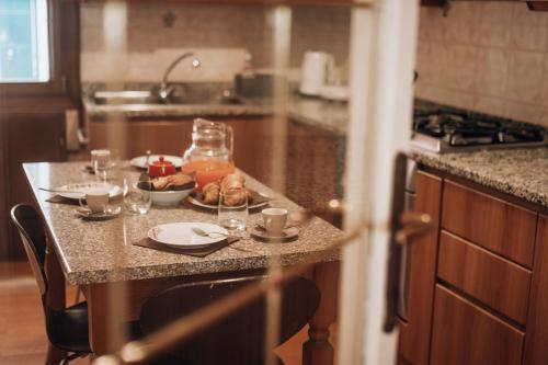 a kitchen with a table with glasses and food on it at Bricola Biennale Apartments in Venice