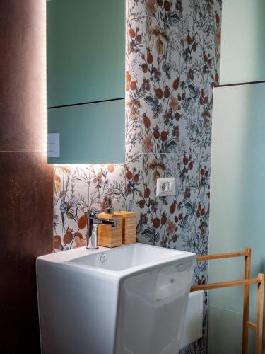 a bathroom with a white toilet and a mirror at B&B Sole Mare Luna in Lu Lioni