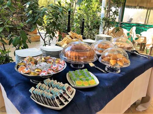 a table with many dishes of food on a blue table at Villaggio Acquamarina in Pisciotta