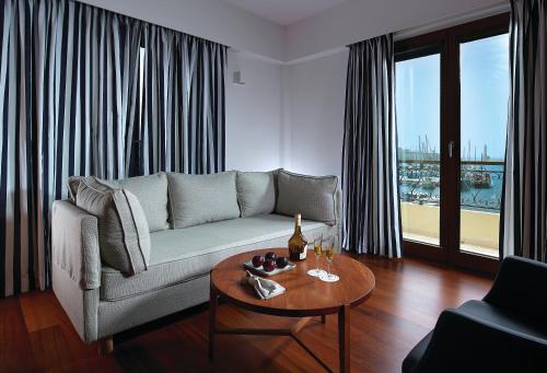 a living room with a couch and a table at Porto Veneziano Hotel in Chania Town