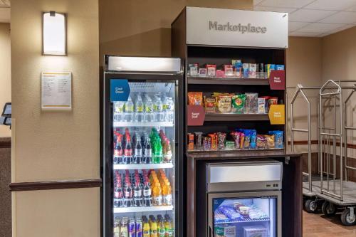 a soda machine in a store with a drink cooler at Comfort Suites Waco Near University Area in Waco