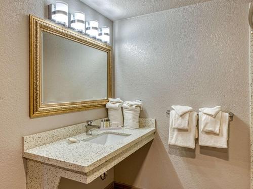 a bathroom with two sinks and a mirror at Amanzi Hotel, Ascend Hotel Collection in Ventura