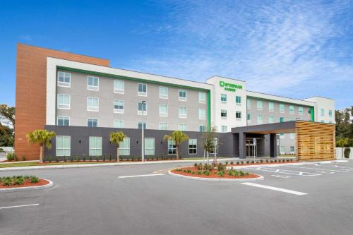 a rendering of a hotel with a parking lot at Wyndham Garden Orlando Airport - Free Airport Shuttle in Orlando