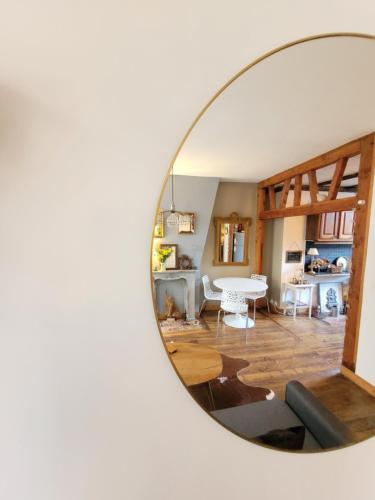 a mirror reflection of a living room with a table at PARKING PRIVE -LE VALENTIN -Coeur Historique -La Clef de Honfleur in Honfleur