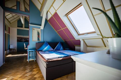 a room with a bed and a window at Rooftop Penthouse Karlsruhe in Karlsruhe
