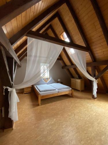 a bedroom with a bed in a attic at Gasthaus Holdermühle in Creglingen