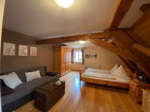 a living room with a couch and a table at Gasthaus Holdermühle in Creglingen
