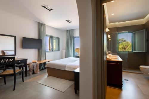 a hotel room with a bed and a bathroom at Villa Benedetta Unique Privacy And Sea View in Sivota