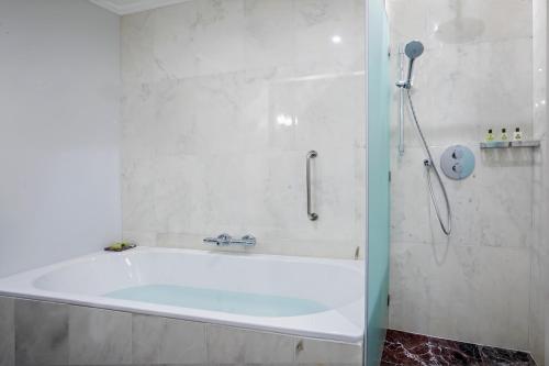 a bath tub in a bathroom with a shower at InterContinental Porto - Palacio das Cardosas by IHG in Porto