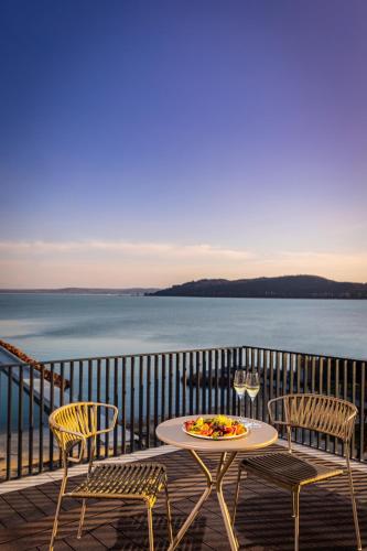 a table and chairs on a balcony with the ocean at LUA Resort - Adults only in Balatonfüred