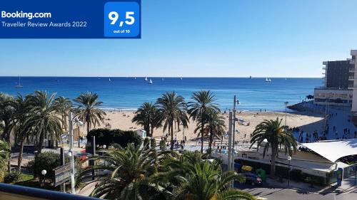 a view of a beach with palm trees and the ocean at Port-Beach Alicante 1 in Alicante