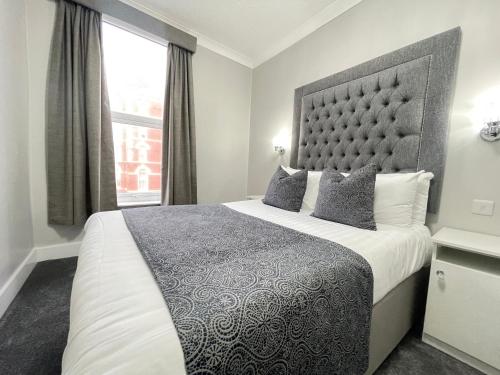a bedroom with a large bed and a window at Park House Hotel in Blackpool