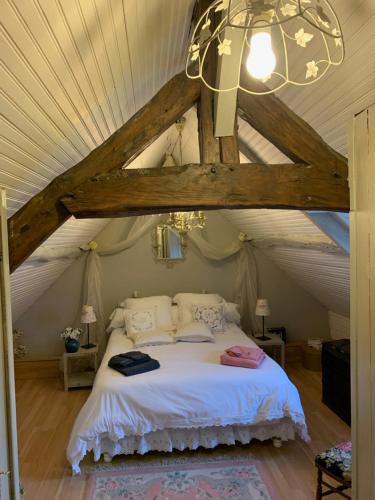 En eller flere senge i et værelse på LA MAISON DE FAMILLE