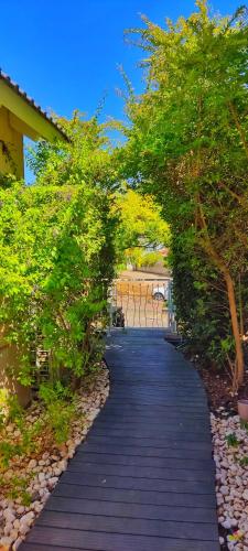 a walkway with trees and plants on it at Luna Bianca in Had Nes