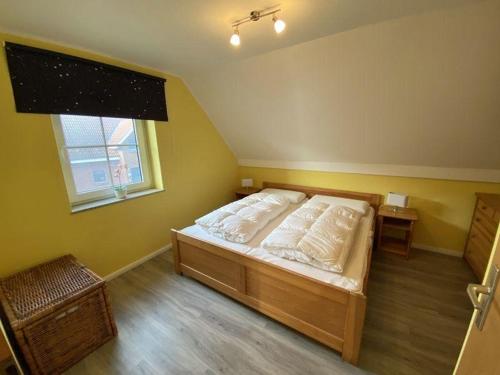 Ένα ή περισσότερα κρεβάτια σε δωμάτιο στο Ferienwohnung-Leichtwind