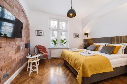 une chambre avec un lit et un mur de briques dans l'établissement Luxury SPA Apartment Old Town Krakow, à Cracovie