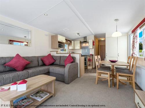 a living room with a couch and a table at Cardigan Bay Holiday Park in Cardigan