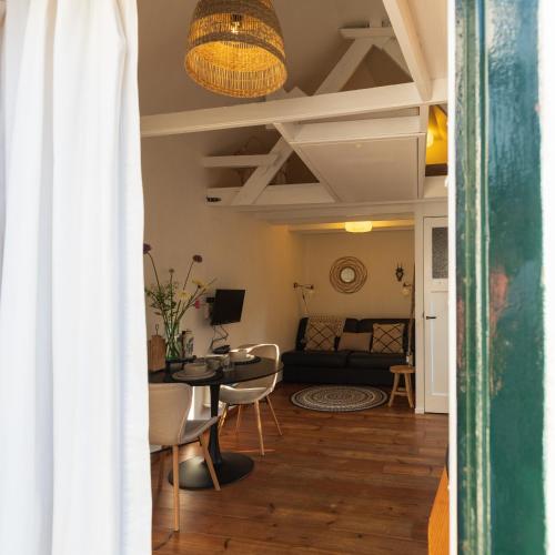 a living room with a couch and a table at Authentiek vakantiehuisje in Terneuzen