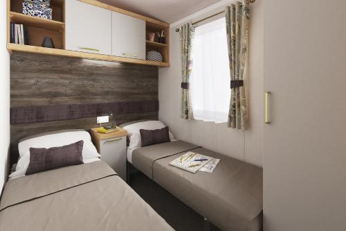 Un pat sau paturi într-o cameră la Cardigan Bay Holiday Park