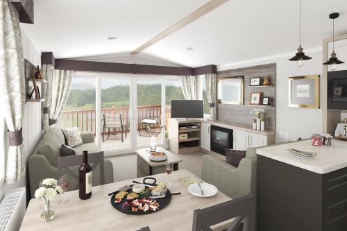 a kitchen and living room with a table and a living room at Cardigan Bay Holiday Park in Cardigan