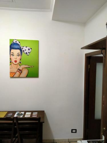a painting of a woman on a wall at La Tegola in Tivoli