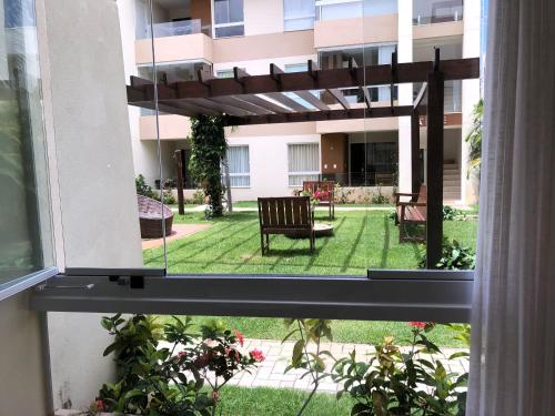 a view of a patio from a window of a building at Porto Smeralda Guarajuba C001 in Guarajuba